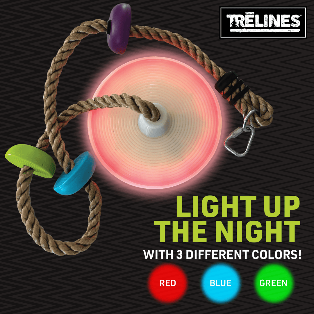 Illuminated rope swing hanging from tree for kids backyard play